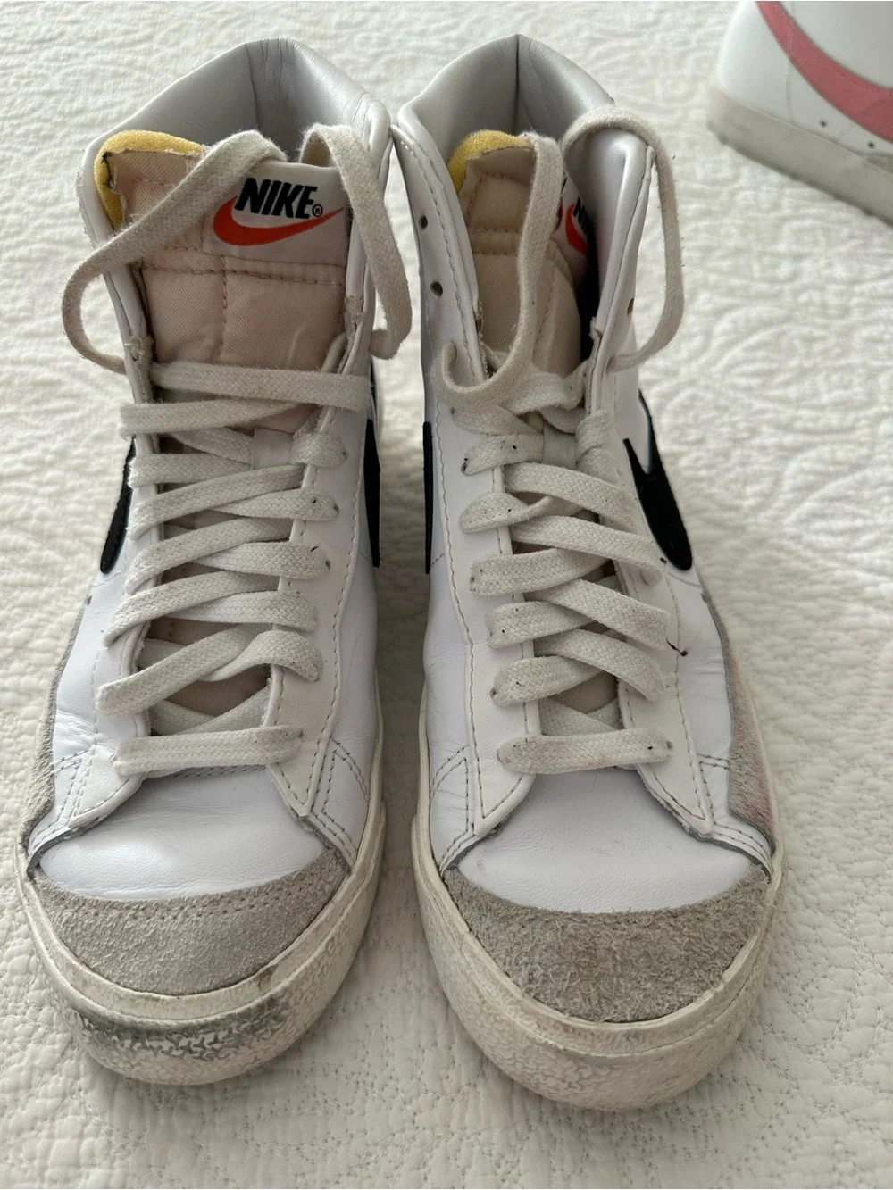Nike White High-Top Sneakers with Black Swoosh and Orange Tongue Accent